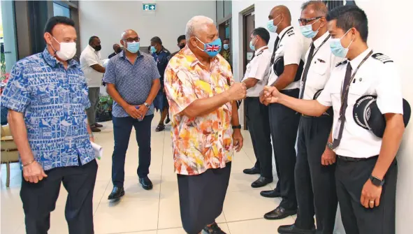  ?? Photo: Leon Lord ?? Fiji Airways chief executive officer and managing director, Andre Viljoen with Prime Minister Voreqe Bainimaram­a greeting the Fijj Airways pilots at the Fiji Airways Aviation Academy in Namaka, Nadi, on October 14, 2021.