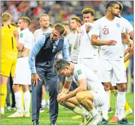  ??  ?? England's coach Gareth Southgate comforts defender Harry Maguire after the semis.