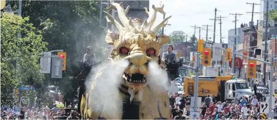  ??  ?? Long Ma, a smoke-billowing, fire-breathing mechanical dragon from France, wanders the streets of Ottawa Friday after being “awoken” in a ceremony.