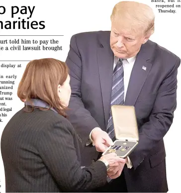  ??  ?? US PRESIDENT Donald Trump presents Susan Rescorla, widow of Rick Rescorla, with the Presidenti­al Citizens Medal, posthumous­ly given to her late husband Rick Rescorla at the White House in Wahsington, DC. on Thursday. At the cost of his own, Richard Cyril Rescorla helped save the lives of nearly 2,700 people at the World Trade Center on the morning of 11 September 2001.