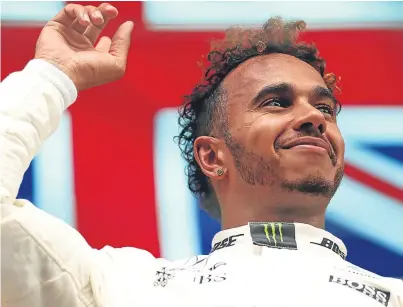  ?? Picture: Getty. ?? Lewis Hamilton celebrates on the podium after his victory in the Belgian GP.