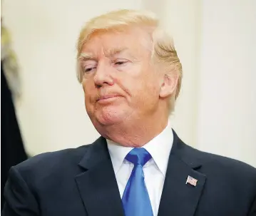  ?? EVAN VUCCI / THE ASSOCIATED PRESS ?? It’s not surprising that U. S. President Donald Trump complained on Wednesday that a law he was signing encroached on his ability to make foreign policy, writes columnist Eli Lake.