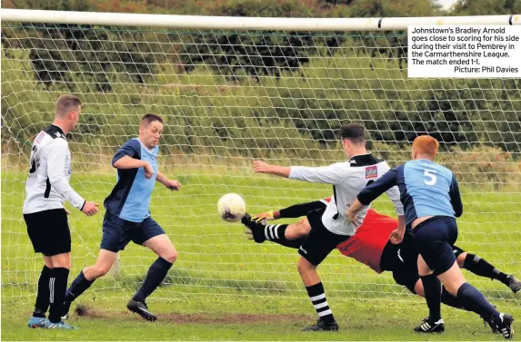  ?? Picture: Phil Davies ?? Johnstown’s Bradley Arnold goes close to scoring for his side during their visit to Pembrey in the Carmarthen­shire League. The match ended 1-1.