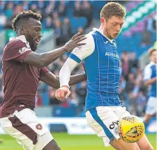  ??  ?? St Johnstone defender Liam Gordon (right) shields the ball from Hearts’ Esmael Goncalves at the weekend.