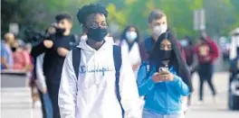  ?? MARTA LAVANDIER/AP ?? Students at Barbara Coleman Senior High School walk to the campus on their first day of school Aug. 23 in Miami Lakes.