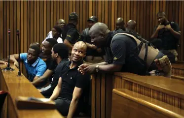  ?? | OUPA MOKOENA Independen­t Newspapers ?? SENZO Meyiwa murder accused Fisokuhle Ntuli listens to a court security guard.