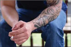  ?? AP PHOTO BY DAVID DERMER ?? Paul Wright smokes a cigarette, Thursday, at the Neil Kennedy Recovery Clinic in Youngstown, Ohio. Republican efforts to roll back “Obamacare” are colliding with the opioid epidemic. Cutbacks would hit hard in states that are deeply affected by the...