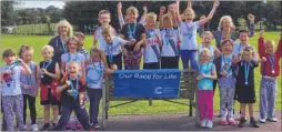  ??  ?? Sellindge Primary School running club members celebrate finishing their own Race for Life