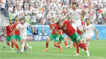  ?? — Reuters ?? Morocco’s Aziz Bouhaddouz scores an own goal for Iran’s first goal.