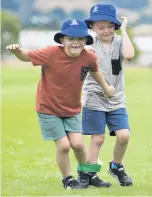  ?? PHOTOS: GERARD O'BRIEN ?? Top: Matteo Giudicelli (9)looks to catch his egg in an egg and spoon race during a tabloid sports day held in Dunedin yesterday for more than 80 children on the last day of Sport Otago's Kelly Sports holiday programme. Above left: Yeva Cockerill (7) sprints to the finish line. Above right: Twins Archie and Arlo Jones (7) test their coordinati­on in the threelegge­d race.