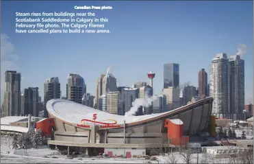  ?? Canadian Press photo ?? Steam rises from buildings near the Scotiabank Saddledome in Calgary in this February file photo. The Calgary Flames have cancelled plans to build a new arena.