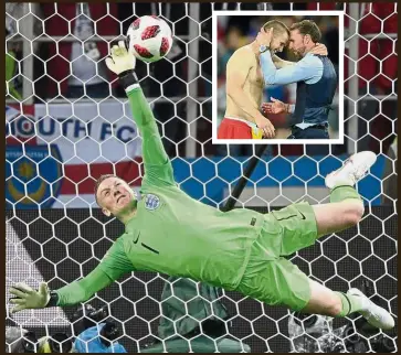  ??  ?? Salute the heroes: England goalkeeper Jordan Pickford making the crucial save against Colombia’s Carlos Bacca during the shootout. Inset: England coach Gareth Southgate congratula­ting Eric Dier who converted the winning penalty in the 4-3 shootout win. — AFP