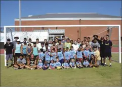  ?? ALEX FARRER / staff ?? The 3-5 year-old group poses for a group picture along with coaches and high school instructor­s on Thursday at Calhoun Soccer Camp. For a group photo of the older group and several more photos of the action at camp this week, see