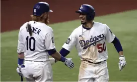  ??  ?? Mookie Betts and Justin Turner celebrate the outfielder’s home run in the sixth inning. Photograph: Tannen Maury/EPA