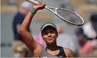  ?? The Associated Press ?? ■ Japan’s Naomi Osaka celebrates after defeating Romania’s Patricia Maria Tig during a first-round match of the French Open tennis tournament at Roland Garros stadium in Paris on May 30, 2021.