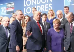  ?? (Peter Nicholls, pool photo via AP, file) ?? U.S. President Donald Trump, center, gestures as he walks off the podium Dec. 4, 2019, after a group photo at a NATO leaders meeting at The Grove hotel and resort in Watford, Hertfordsh­ire, England.