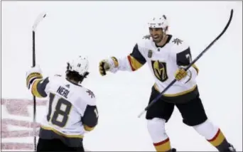  ?? ROSS D. FRANKLIN — THE ASSOCIATED PRESS ?? Vegas Golden Knights left wing James Neal (18) celebrates his game-wining goal with defenseman Jason Garrison (7) during overtime of Saturday’s game against Arizona.