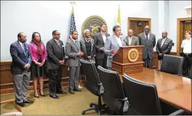  ?? AP ?? Columbus Mayor Andrew Ginther (front center) joined by city officials including Columbus Division of Police Chief Kim Jacobs (far right) expresses his concern Tuesday over a police officer captured on video apparently kicking a suspect in the head.