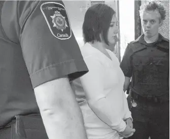  ??  ?? Terri-Lynne McClintic, centre, is escorted into court in Kitchener, Ont., in this file shot from Sept. 12, 2012.