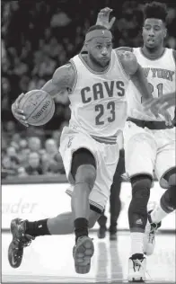  ?? AP/KATHY WILLENS ?? Cleveland Cavaliers forward LeBron James (23), driving past New York Knicks guard Iman Shumpert (21), scored 23 points Thursday night in the Cavaliers’ 90-87 victory at Madison Square Garden in New York.