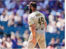  ?? DAVID ZALUBOWSKI/ASSOCIATED PRESS ?? San Diego pitcher Jake Arrieta, making his first start for the Padres, had to leave with an injured left hamstring after yielding a homer to Colorado’s Dom Núnez in the fourth inning of their game Wednesday.