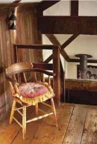  ??  ?? BELOW In the loft above the kitchen, a humble chair has a cushion made from an old patchwork quilt.