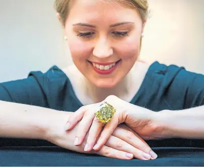  ??  ?? The ‘Graff Vivid Yellow’ diamond sold for $16.3 million at auction in May.