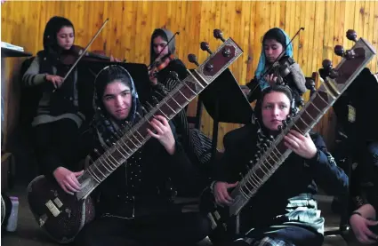  ?? Wakil Kohsar / AFP ?? The women of Afghanista­n’s first all-female orchestra are charting a new destiny for themselves through music.