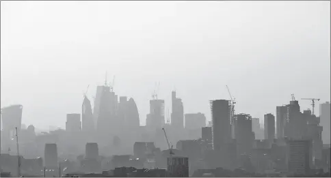  ??  ?? Buildings and constructi­on cranes seen through a heat haze in London. — Reuters file photo