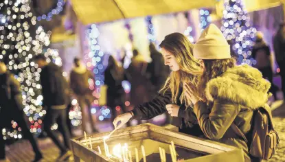  ??  ?? Worshipper­s light candles as they attend Christmas mass at Saint Antuan Church in the Beyoğlu district of Istanbul.