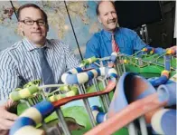  ?? JAMES PARK/OTTAWA CITIZEN ?? ProSlide vice-president of business developmen­t Jeff Janovich, left, and founder Rick Hunter with waterslide models produced by a 3D printer.