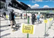  ??  ?? Social distancing for skiers and snowboarde­rs at the Black Mountain Express lift for the reopening of the Arapahoe Basin ski area May 27.