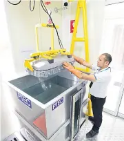  ??  ?? A researcher tests a lithium battery at PTEC in Pathum Thani. Mercedes-Benz will apply this lab’s activities to a new battery assembly plant in Samut Prakan.