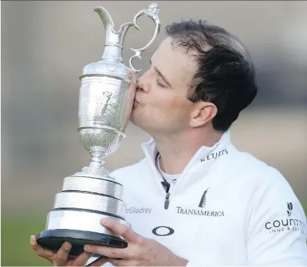  ?? PETER MORRISON/ THE ASSOCIATED PRESS ?? American Zach Johnson plants a kiss on the Claret Jug after winning the British Open in a four- hole playoff at the Old Course in St. Andrews, Scotland, on Monday. Johnson, winner of the 2007 Masters, began play as a 100- to- 1 longshot.