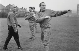  ??  ?? Ian St John warms up, watched by Liverpool’s manager Bill Shankly in January 1967. Photograph: Evening Standard/Getty Images