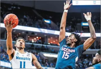  ?? BRAD VEST/THE COMMERCIAL APPEAL/AP PHOTO ?? Antwann Jones Jr. of Memphis, left, goes up for a shot against UConn’s Sidney Wilson during Sunday’s game at Memphis, Tenn. Memphis won 78-71.