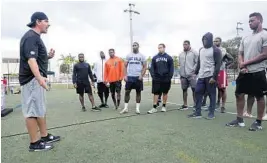  ?? JOE CAVARETTA/SUN SENTINEL ?? Fitness trainer Pete Bommarito, left, talks to this year’s class of NFL prospects he is helping to train for the NFL scouting combine.