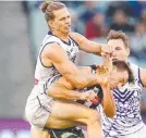  ??  ?? OUCH: Nat Fyfe hits Levi Greenwood.