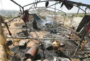  ?? JAAFAR ASHTIYEH/GETTY-AFP ?? A Palestinia­n inspects his damaged belongings Saturday in Al Mughayir in the West Bank.