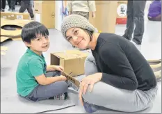  ?? KIRK STARRATT ?? Three-year-old Lewyn Pittoello and his mom Sarah Pittoello of Hortonvill­e play at the cardboard box building station at the Kentville Plays anniversar­y event.