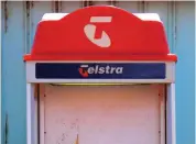  ?? REUTERSPIX ?? File photo shows a public phone booth displaying the logo for Telstra Corp Ltd in Queensland, Australia.