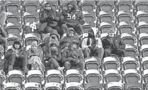  ?? NAM Y. HUH/AP ?? Snow covers empty seats at Soldier Field in Chicago on Sunday as fans arrive for a game between the Chicago Bears and the New York Giants.