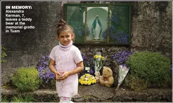  ??  ?? in memory: Alexandra Kerman, 7, leaves a teddy bear at the memorial grotto in Tuam