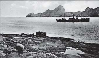  ??  ?? Left, forty years after the St Kildans left their island home food was being dropped in nets by aeroplane for the military personnel. One day a netful of frozen food, on hitting the ground, burst open and a chicken flew out breaking the collarbone of the commanding officer who had come to watch. and above, provisions landed from the SS Dunara Castle being carried up to the houses in Village Bay, St Kilda. Times; Photograph The Oban Photograph supplied by Iain Thornber