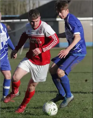  ??  ?? Dillon Redmond of Moyne Rangers is tracked by Ciarán Marlowe of Wexford Celtic.