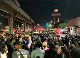  ?? (AP/Eduardo Castillo) ?? Reporters stand at a police barricade barring access to the scene of a subway accident Wednesday after a section of Line 12 of the subway collapsed in Mexico City.