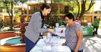  ?? PHOTO VINCENT OSUNA ?? Ventanilla De Salud program coordinato­r Adriana Buelna (left) provides Villa De Las Flores resident Paola Ramirez with a free pair of reading glasses during the senior citizens health fair on Tuesday at the Villa De Las Flores apartment complex in Calexico.