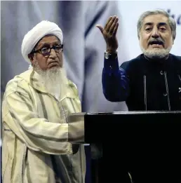  ?? APFILE ?? Former Afghan President Sibghatull­ah Mujadidi, left, accompanie­s Afghan presidenti­al candidate Abdullah Abdullah, right, during a 2014 ceremony. Mr. Mujadidi died at age 93.