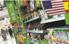  ?? Andy Wong / Associated Press ?? Nuts and sweets from the U.S. fill shelves in a Beijing supermarke­t. The products face new import duties in China.