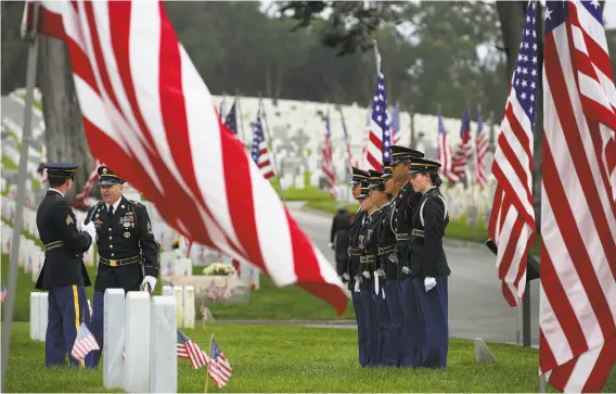  ?? Photos by Liz Hafalia / The Chronicle ?? The U.S. Army Reserve Color Guard from Camp Parks in Dublin practices before the Memorial Day ceremony at the Presidio cemetery.